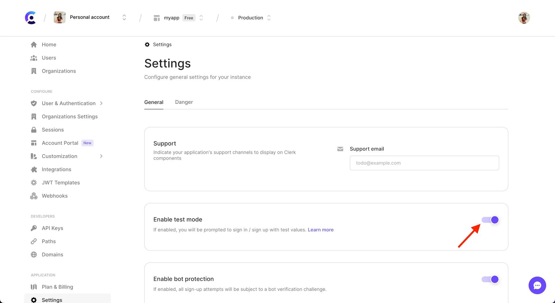 The 'Enable test mode' section of the Settings page in the Clerk Dashboard. There is a red arrow pointing to the toggled, which is toggled on.